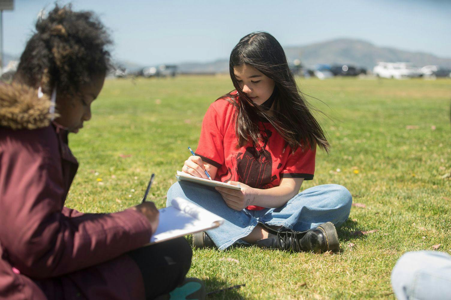 ati north scottsdale students sitting on grass writing in notepads