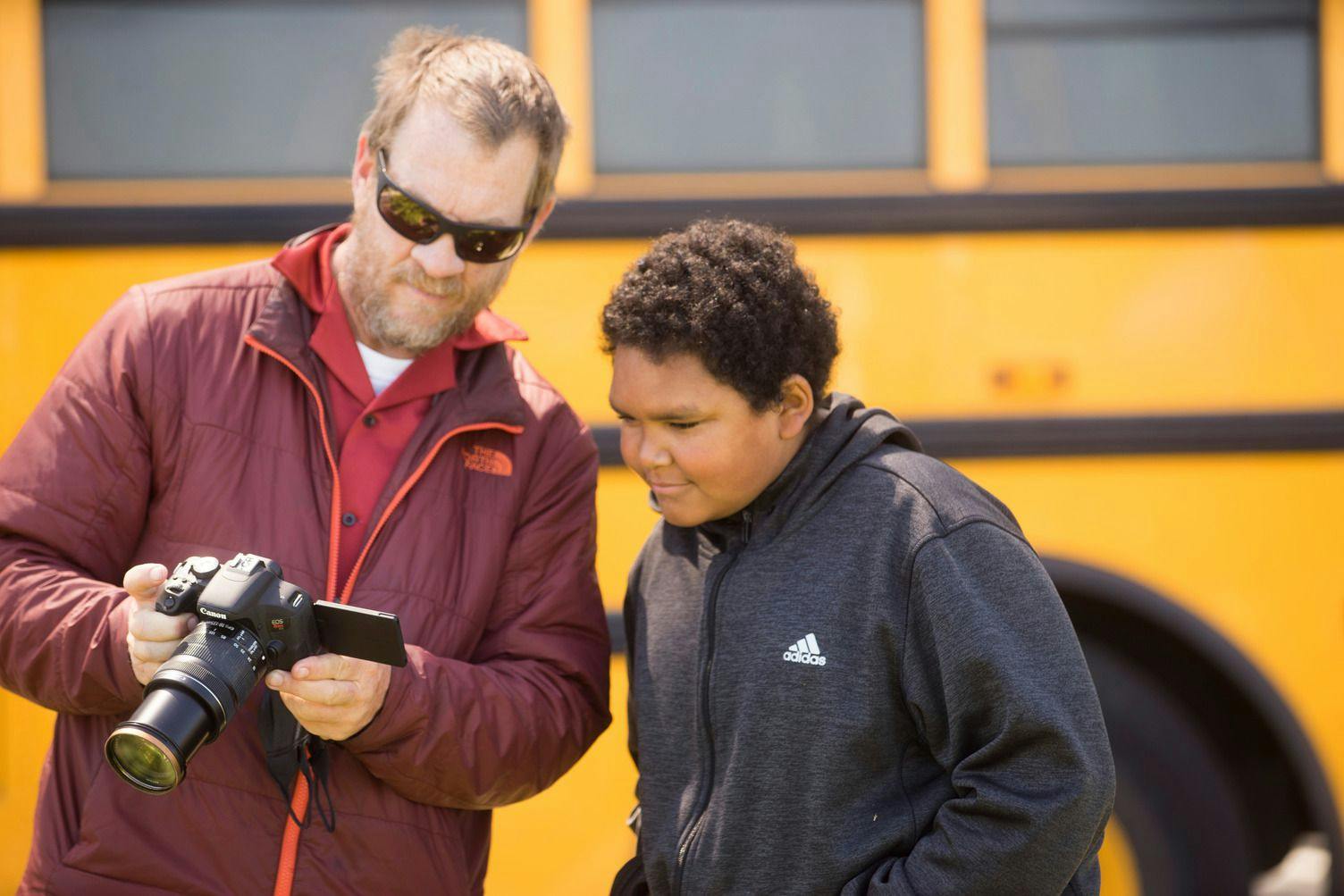 ati coach and student looking at photos on a camera