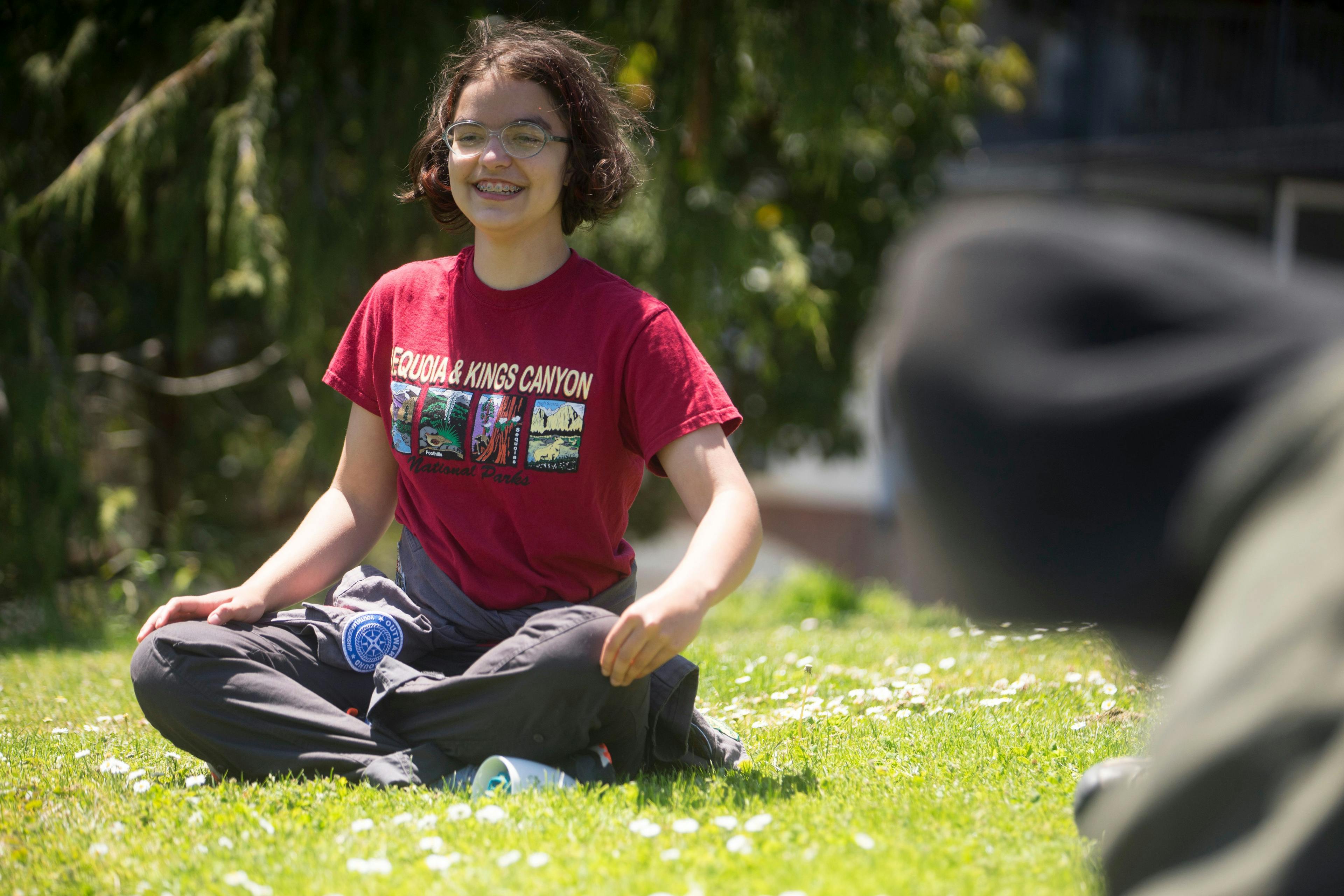 ati north scottsdale student sitting in grass smiling