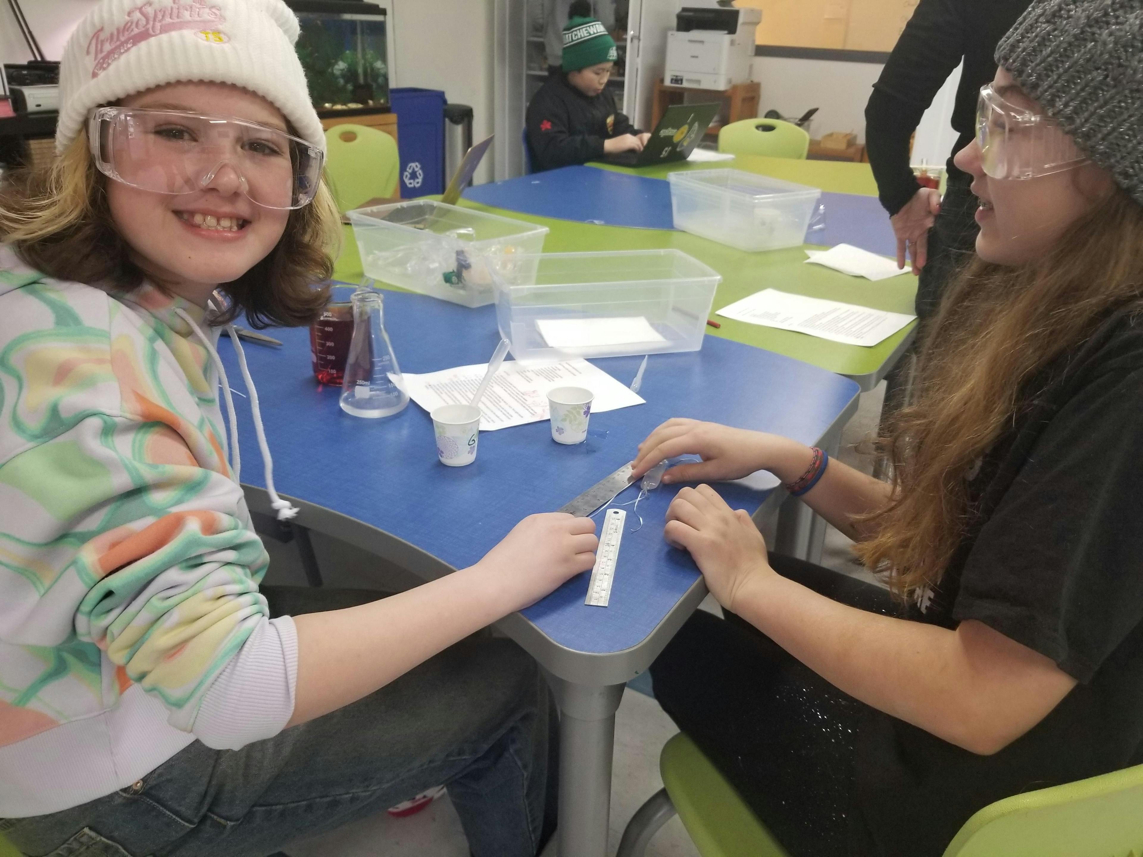 two ati toronto students looking through microscopes