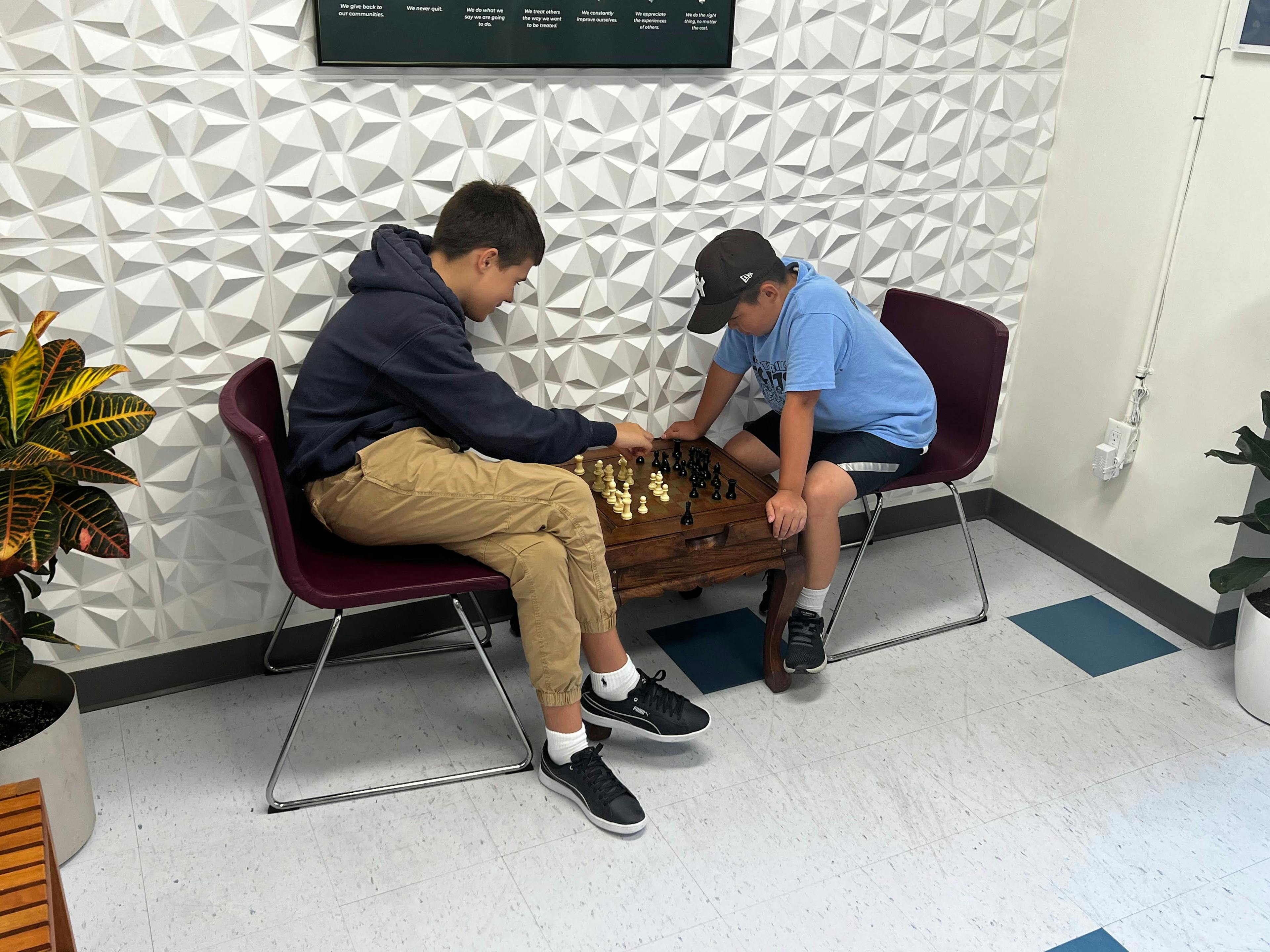 two Guidepost Academy Toronto students playing chess.